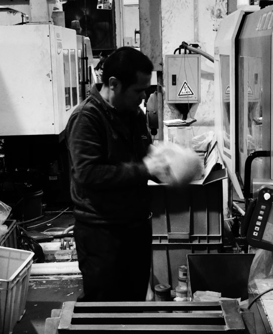 a man working on a machine in a factory